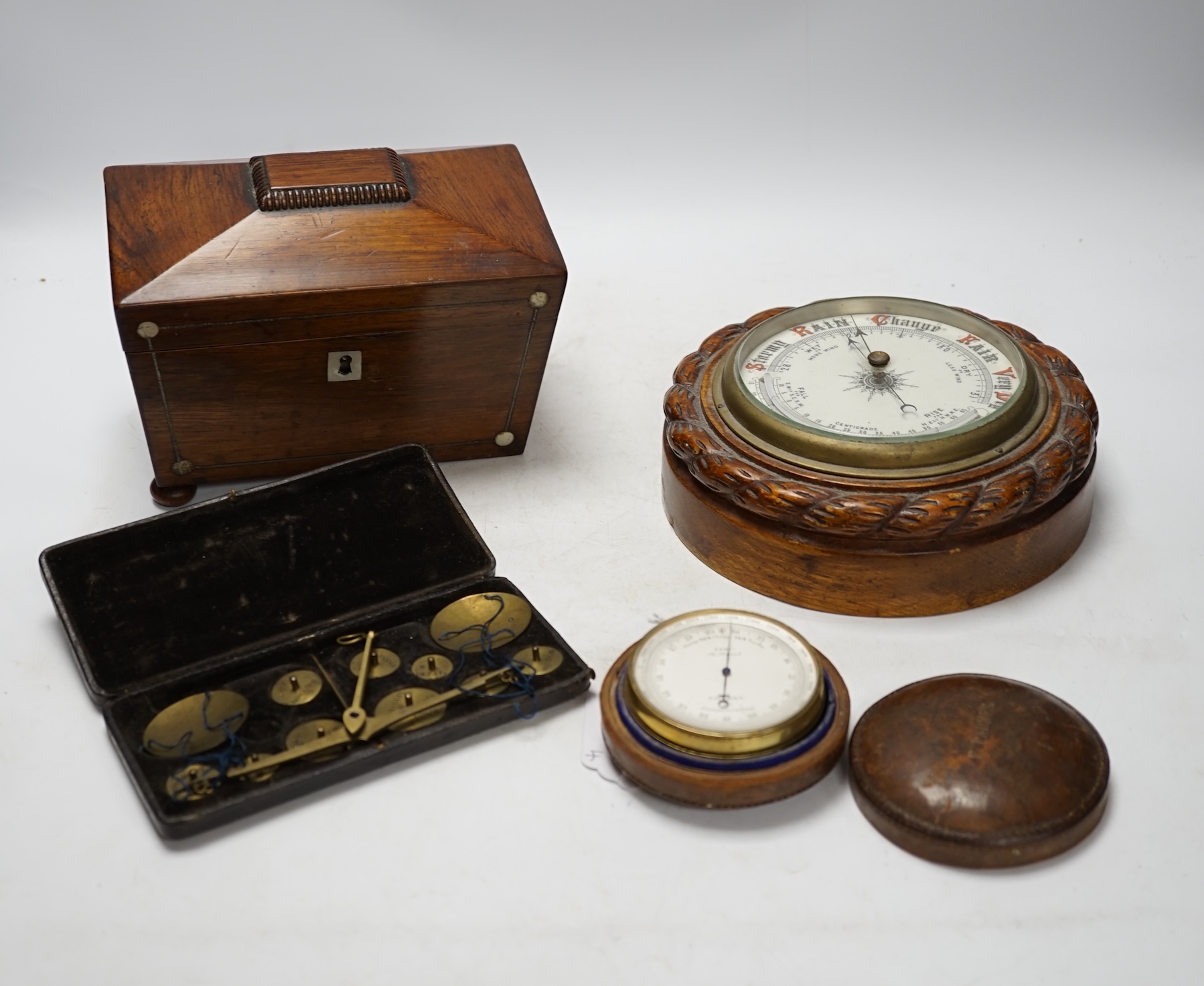 A cased travelling set of scales, a Cary of London small travelling barometer, a tea caddy and a small wall barometer. Condition - fair